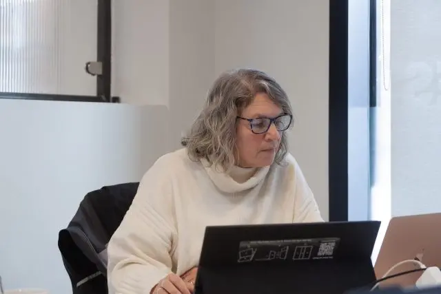 Female team member working on her laptop